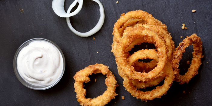 Crispy onion rings with dipping sauce at Screw City Tavern Restaurant Bar, Rockford Illinois.
